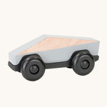 Tobe Poly Car in light grey and black, on a cream background. The car is made from wood in a geometric shape to give a futuristic feel.
