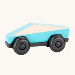 Tobe Poly Car in light blue and black, on a cream background. The car is made from wood in a geometric shape to give a futuristic feel.