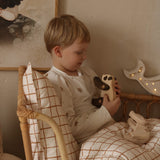 A child playing with the Tobe wooden panda toy available at Babipur 