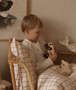 A child playing with the Tobe wooden panda toy available at Babipur 