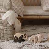 A Tobe Wooden Panda toy standing next to a polar bear on a fluffy rug. These movable animal toys are available at Babipur. 