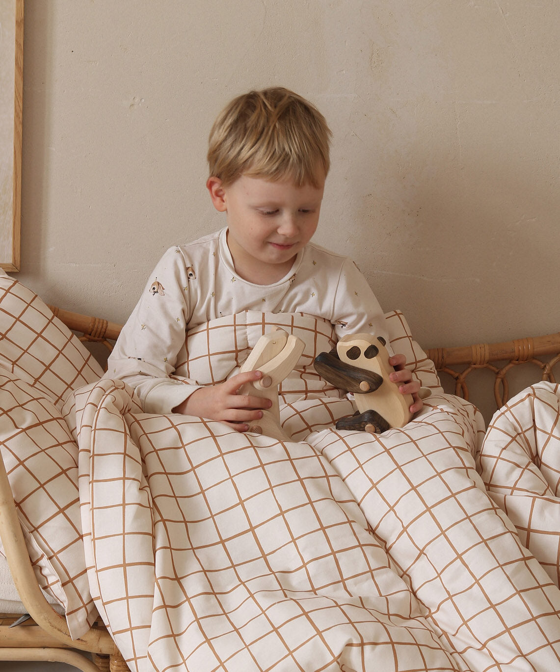 A child playing with a Tobe wooden panda  and polar bear animal toys that are available at Babipur 