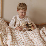 A child playing with a Tobe wooden panda  and polar bear animal toys that are available at Babipur 