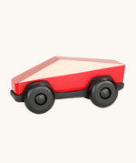 Tobe Poly Car in red and black, on a cream background. The car is made from wood in a geometric shape to give a futuristic feel.