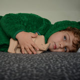 A child playing with the natural unpainted Tobe wooden rhinoceros toy available at Babipur 