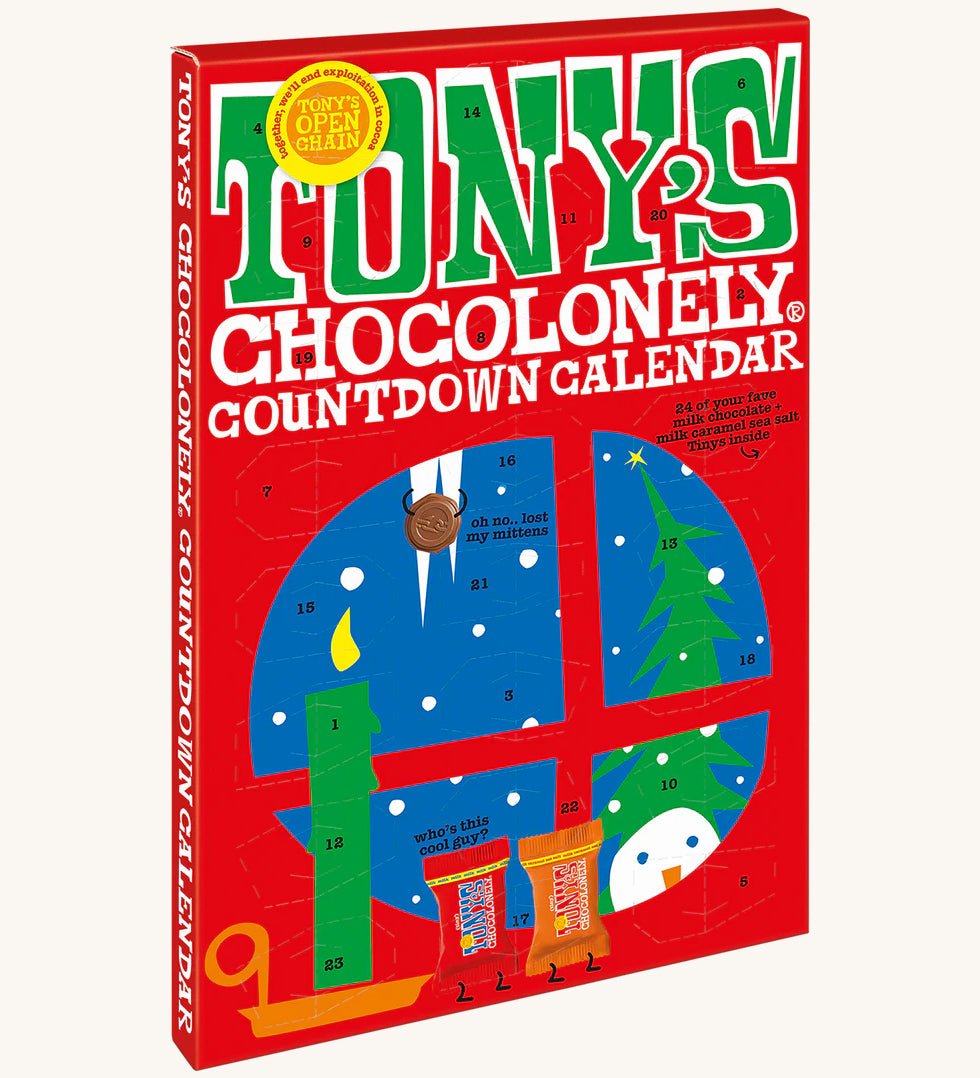 An angeld view of the The front of the Tony's Chocolonely Chocolate Advent Calendar - Fairtrade and Organic - Small 216g showing the calendar windows ready to open. The image is on a cream background