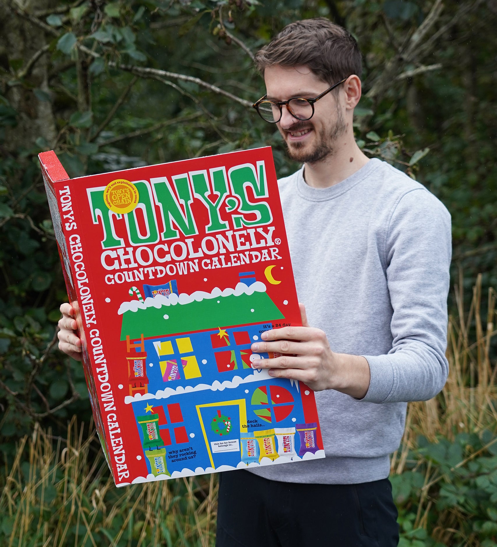 A person holding the Tony's Chocolonely Fairtrade Advent Calendar, looking inside at the delicious chocolates