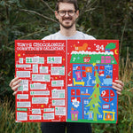 A person holding the Tony's Chocolonely Advent Calendar showing the inside which has one side filled with chocolates and the other side which has fun facts and ideas to do for the day