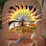 A cosy festive display with the Toverlux 12 holy nights sonne mond und erde silhouette inside a lamp. Silhouette features each date with a cut out for a message. Silhouette and lamp available at Babipur