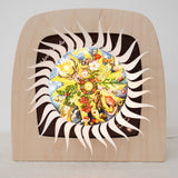 An open Toverlux advent calender sonne mond und erde silhouette available at Babipur.  Displayed in a wooden Toverlux lantern  showing all of the windows open revealing a lit up silhouette 