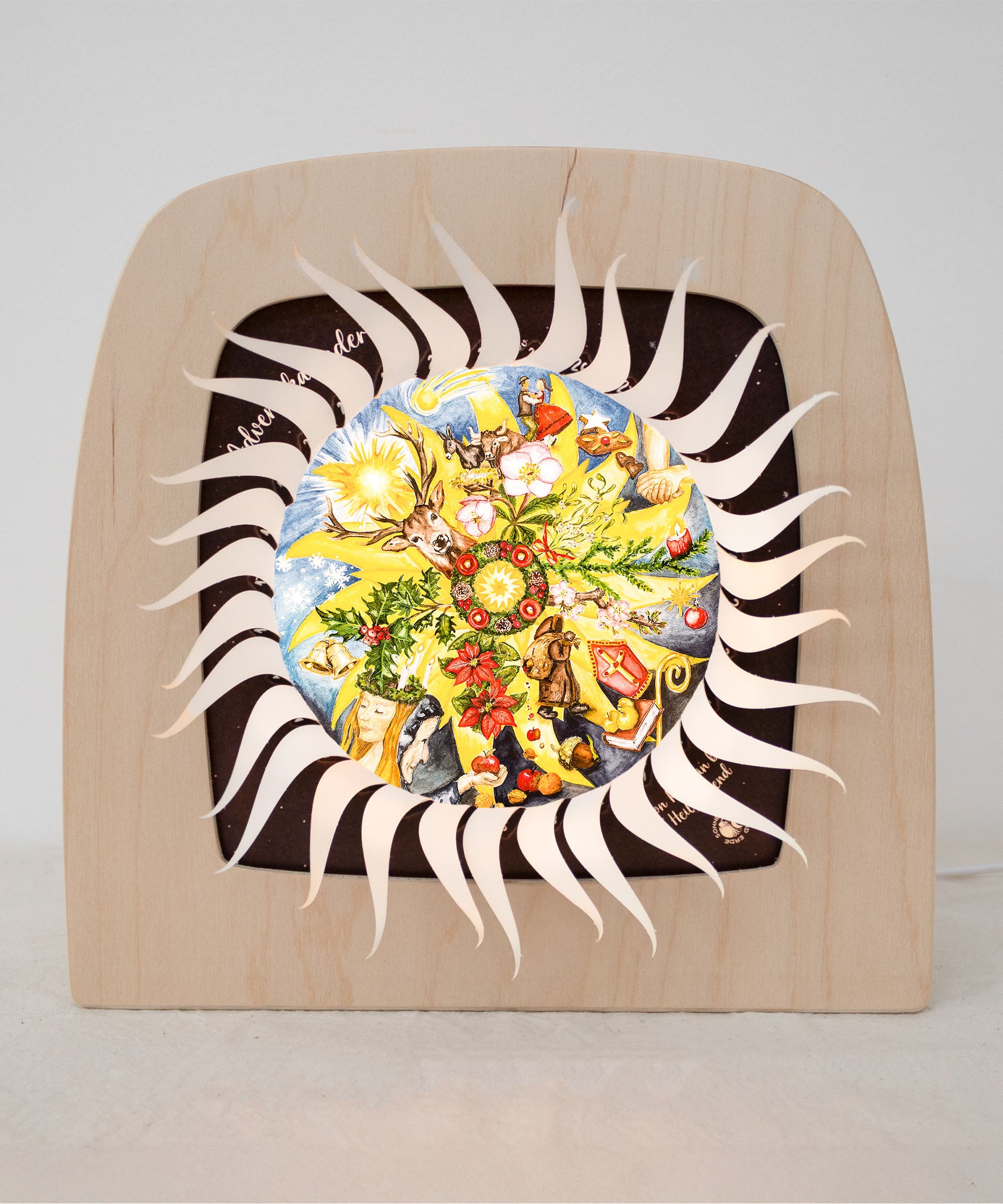 An open Toverlux advent calender sonne mond und erde silhouette available at Babipur.  Displayed in a wooden Toverlux lantern  showing all of the windows open revealing a lit up silhouette 
