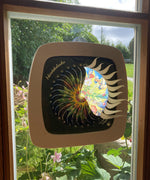 A Toverlux sonne mond und erde nativity advent calendar silhouette inside a wooden magic frame available at Babipur. Calendar some of the windows open revealing a lit up silhouette. 