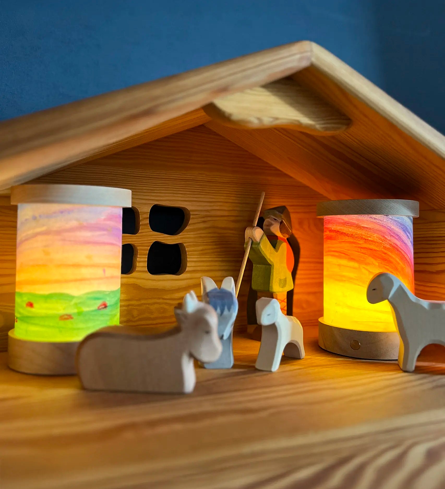Toverlux personalised lantern shades, decorated with watercolours, in a nativity setting with Ostheimer figures and a barn.