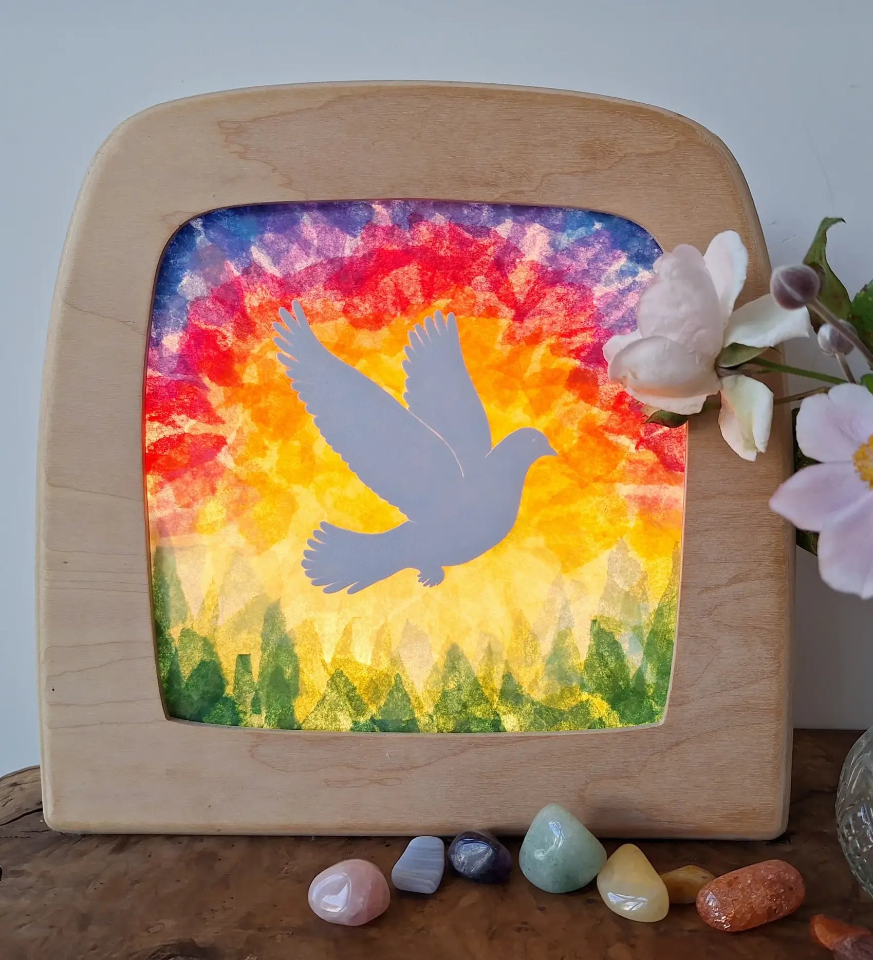 Toverlux DIY Transparencies with a white dove and Spring sky artwork shown in a wooden magic window frame.