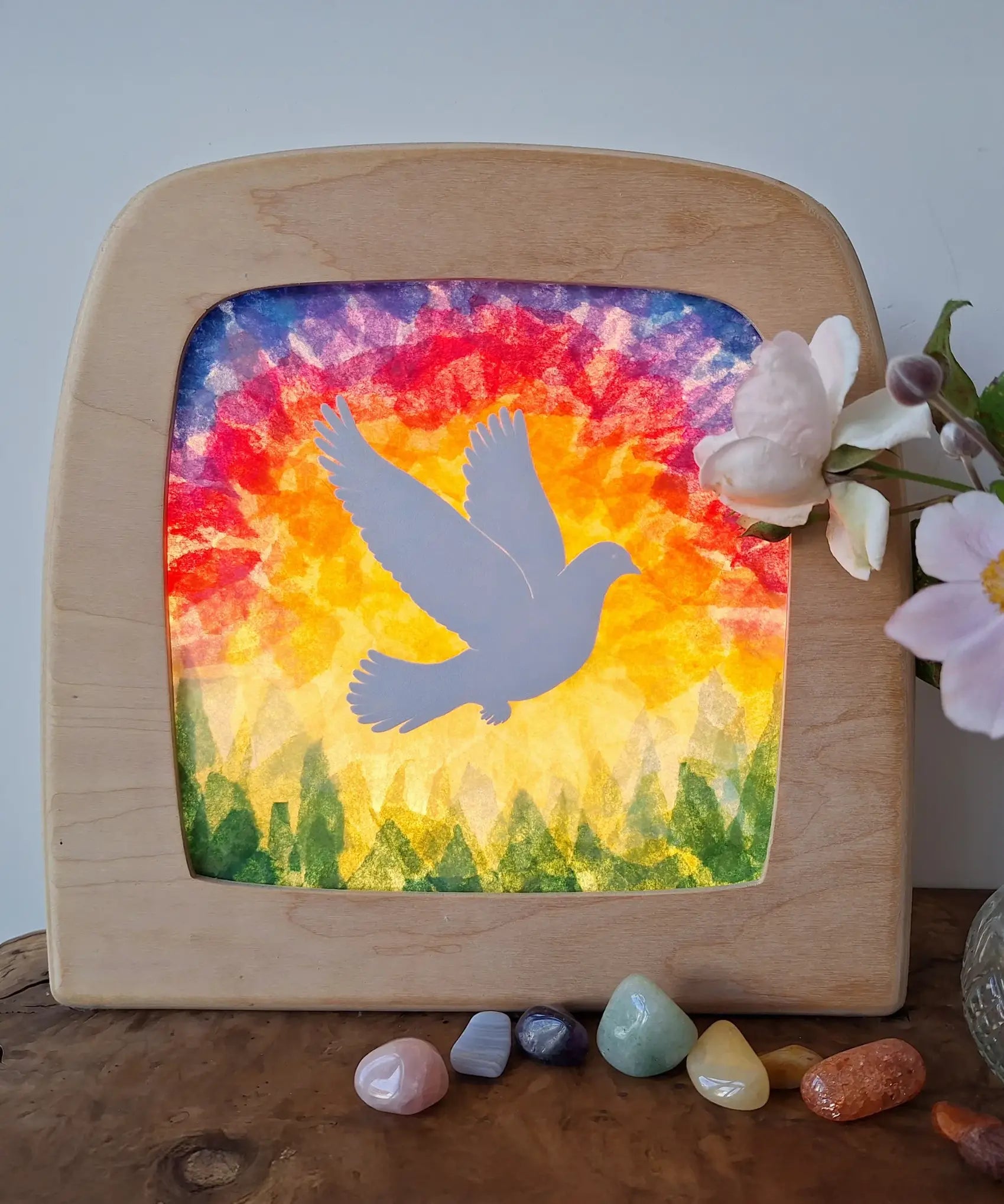 Toverlux DIY Transparencies with a white dove and Spring sky artwork shown in a wooden magic window frame.