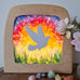Toverlux DIY Transparencies with a white dove and Spring sky artwork shown in a wooden magic window frame.
