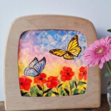 Toverlux DIY Transparencies with red poppies and butterflies artwork shown in a wooden magic window frame.