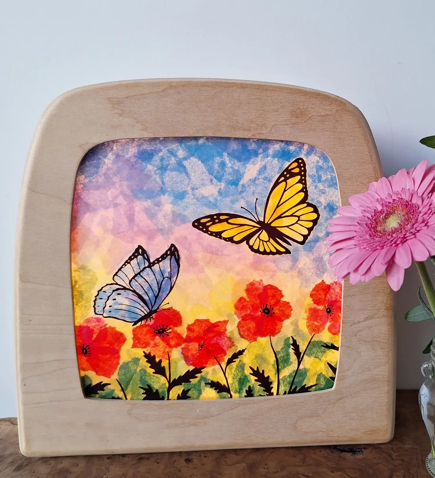 Toverlux DIY Transparencies with red poppies and butterflies artwork shown in a wooden magic window frame.