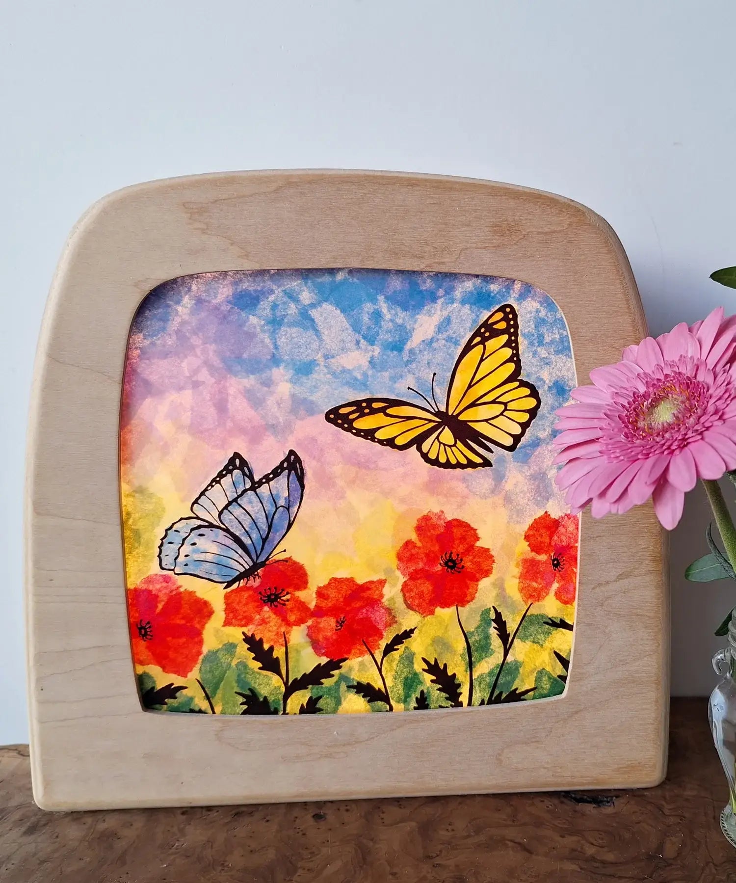 Toverlux DIY Transparencies with red poppies and butterflies artwork shown in a wooden magic window frame.