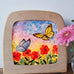 Toverlux DIY Transparencies with red poppies and butterflies artwork shown in a wooden magic window frame.