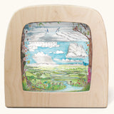 Toverlux Edulux watercycles silhouette featuring Stephanie Green's Clouds artwork. The silhouette is shown in a wooden frame. 