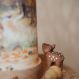 A close up of the Toverlux Eentje Van Margo light wish illustration showing the detail on the Ostheimer baby deer figure displayed with the lantern, both available at Babipur. 