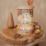 A cosy Autumnal display with various Ostheimer wooden figures and the Toverlux rechargeable lantern with a silhouette inserted. Both the illustration and lantern are available at Babipur.