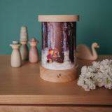 A fully assembled Toverlux illustration and rechargeable lantern displayed with various wooden figures available at Babipur.
