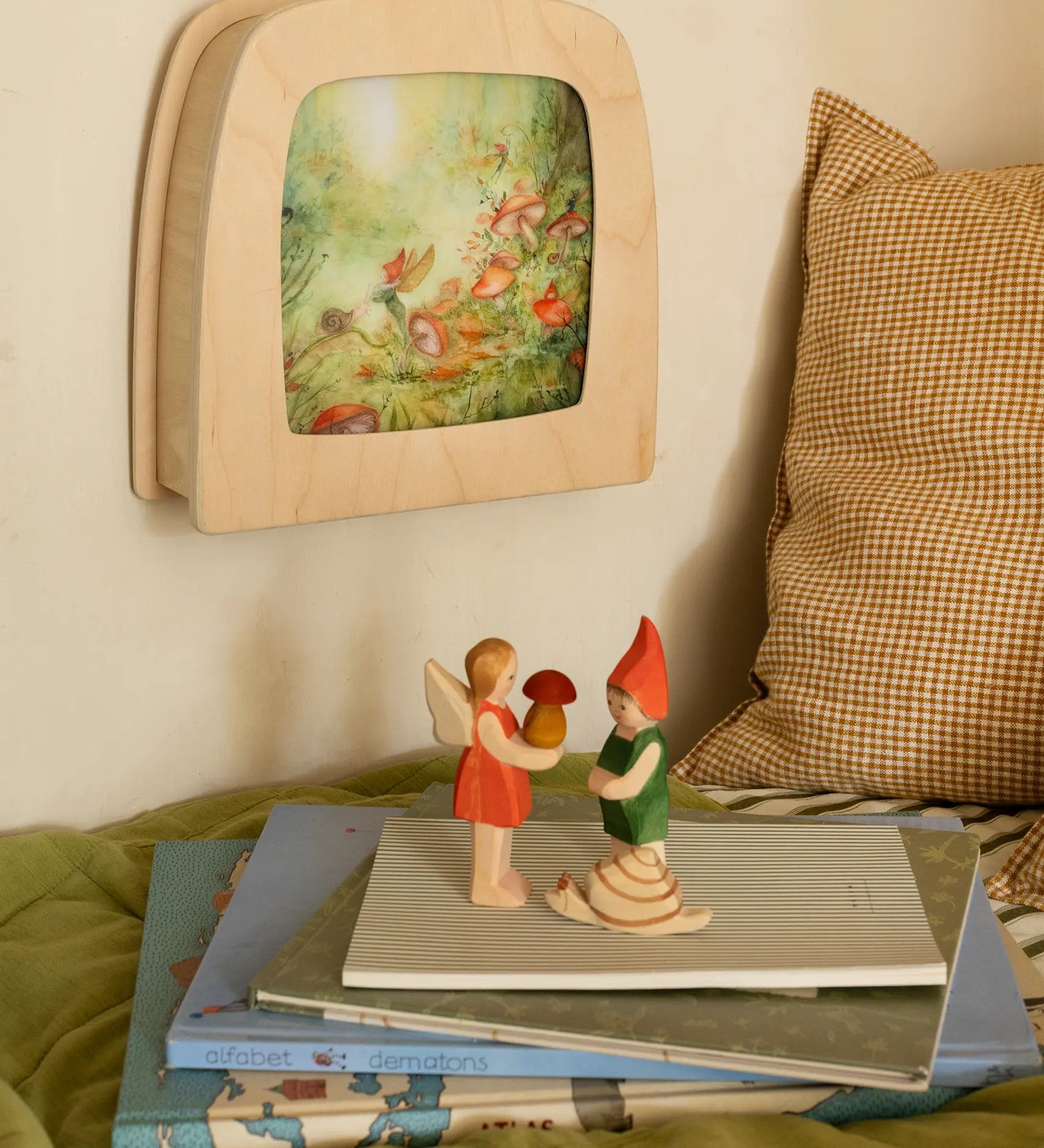 Toverlux Magic lamp on wall with Anne Illustrates toadstool artwork next to Ostheimer Pepe, Sumselinchen and snail.
