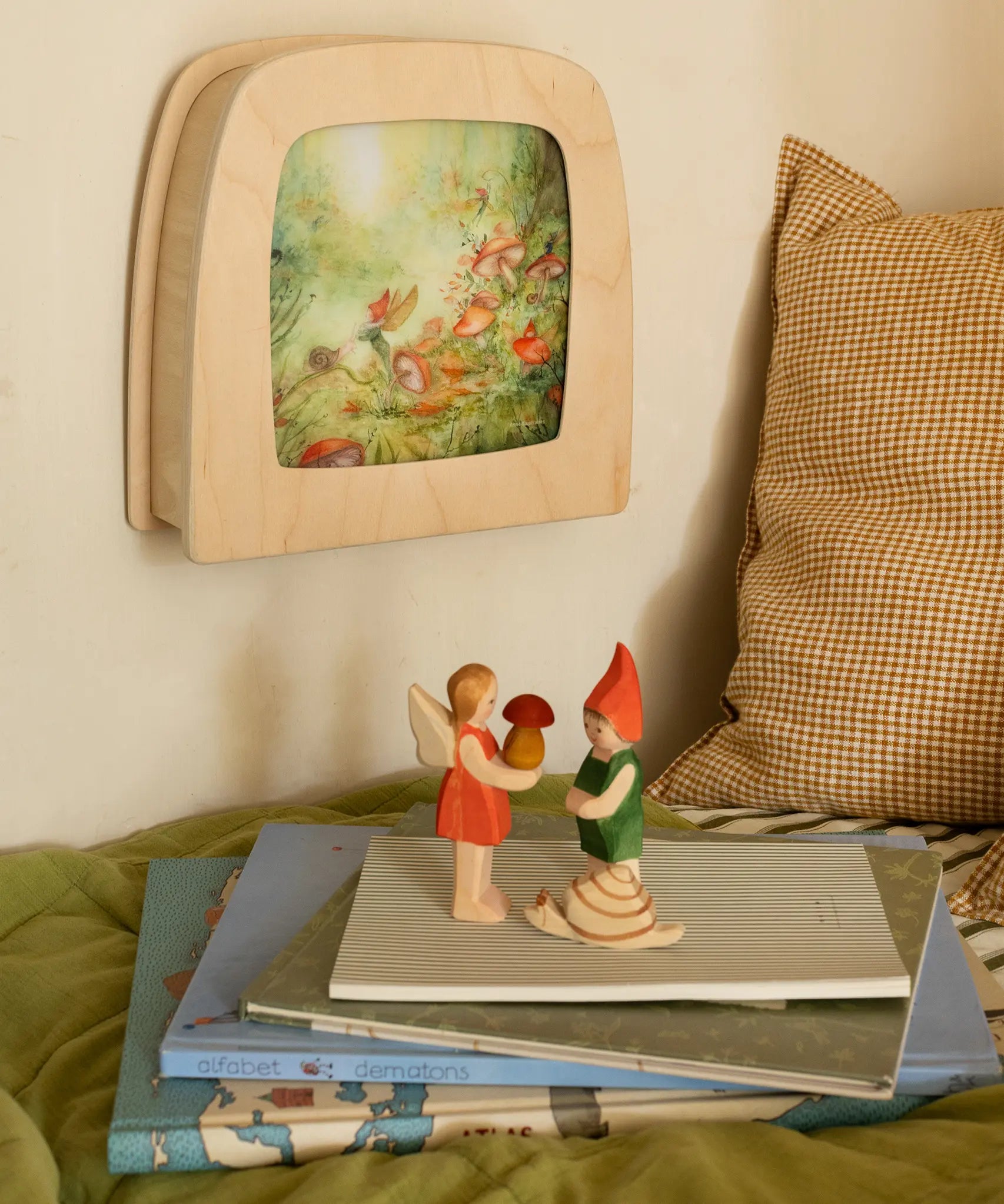 Toverlux Magic lamp on wall with Anne Illustrates toadstool artwork next to Ostheimer Pepe, Sumselinchen and snail.