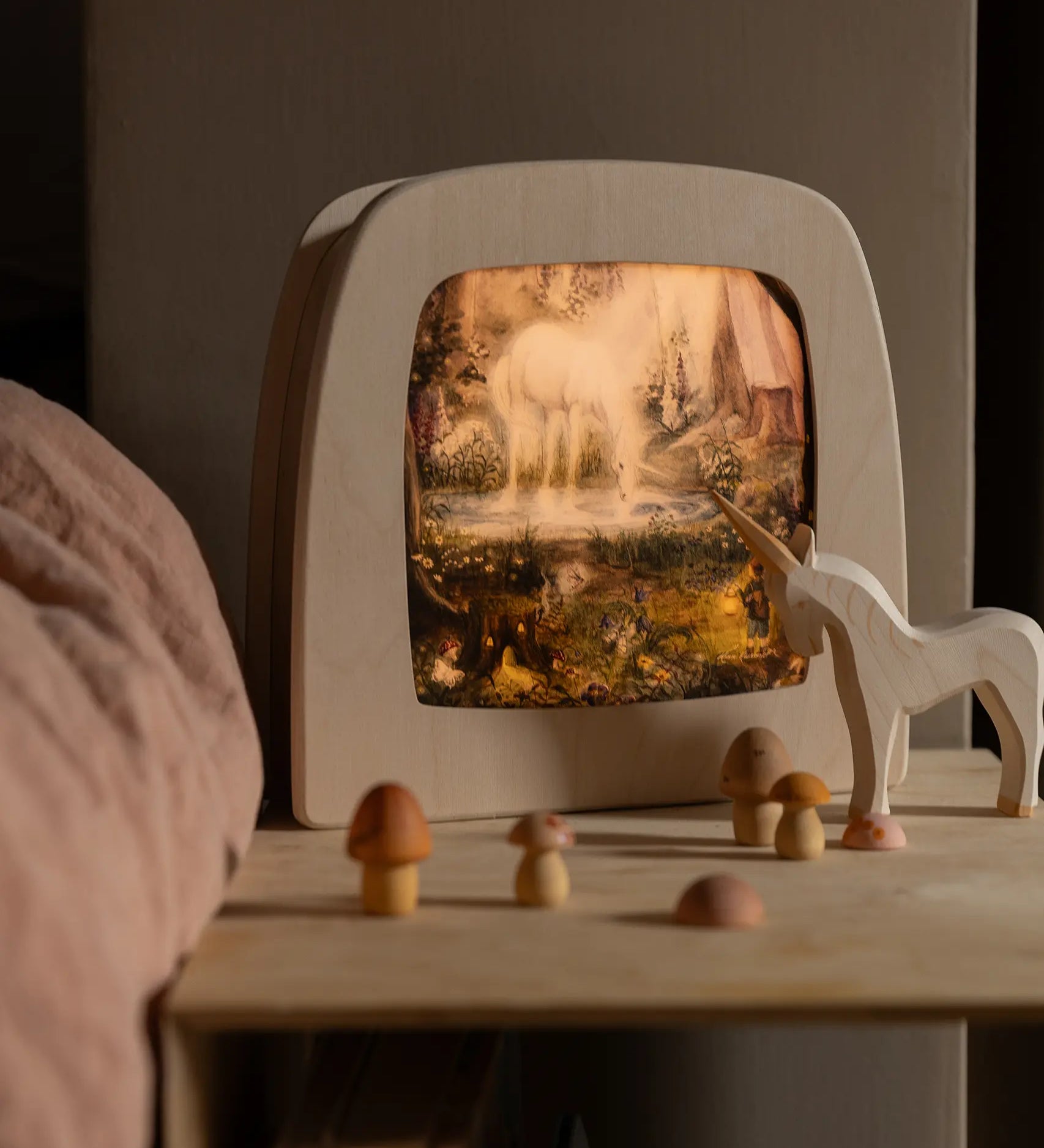 Toverlux Magic Lamp with unicorn artwork by Mhairi Hellbrandt, Ostheimer wooden unicorn figure and Grapat toy mushrooms.