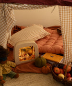 Toverlux Magic Lamp with cosy autumn artwork by Robin Pieterse in a child's den with Nanchen doll.