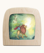 Toverlux Knight silhouette by Anne illustrates that fit in a wooden magic lamp. Shows pencil style of a boy riding a lion and castle in the background