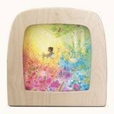 Toverlux into bloom silhouette by Anne illustrates that fit in a wooden magic lamp. Shows watercolour style of a girl in a floral field 