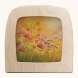 Toverlux amber fields silhouette by Baukje Exler. A pastel illustration of warm floral field. Silhouette in wooden magic lamp