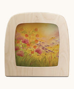 Toverlux amber fields silhouette by Baukje Exler. A pastel illustration of warm floral field. Silhouette in wooden magic lamp