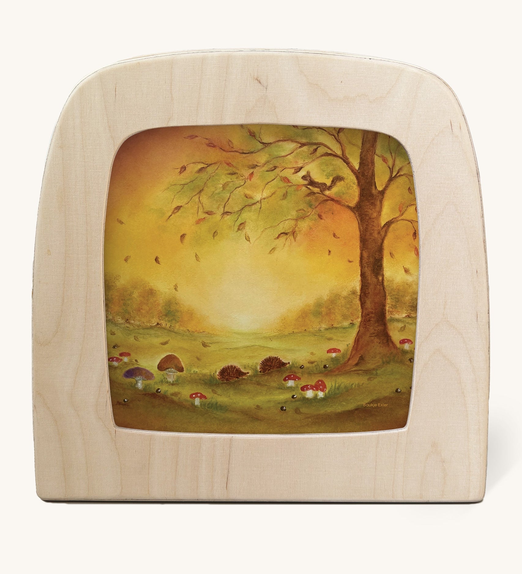 A Toverlux silhouette in the magic lamp with a Autumn leaves silhouette inside by Baukje Exler available at Babipur. A pastel illustration of hedgehogs near mushroom and under a tree with falling autumn leaves