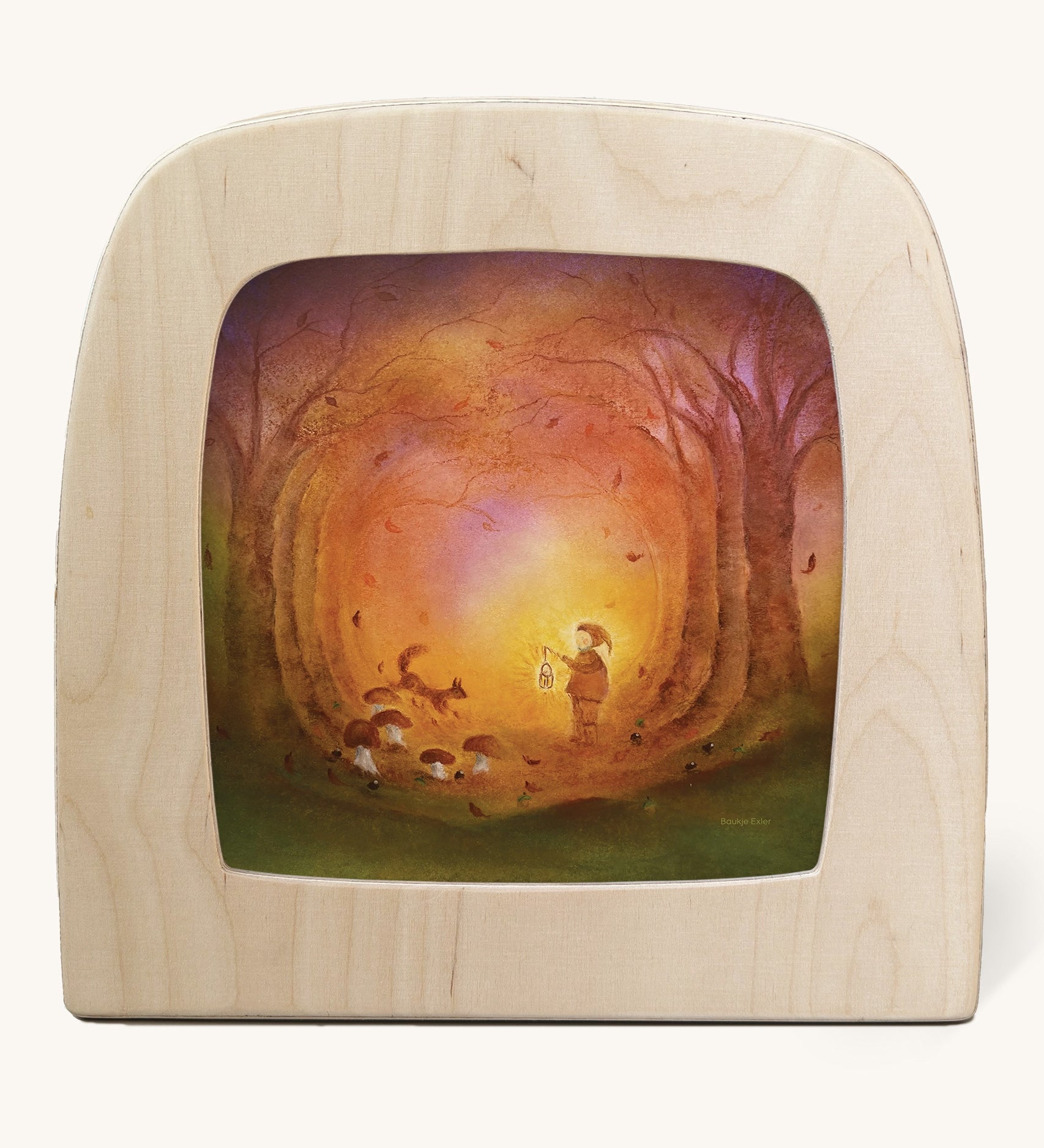 A Toverlux silhouette in the magic lamp with a Autumn light silhouette inside by Baukje Exler available at Babipur. A pastel illustration of a small child walking though Autumn woodland with a glowing torch