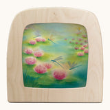 Toverlux dragonfly silhouette by Baukje Exler. A pastel illustration of flying dragonflies. Silhouette in wooden magic lamps