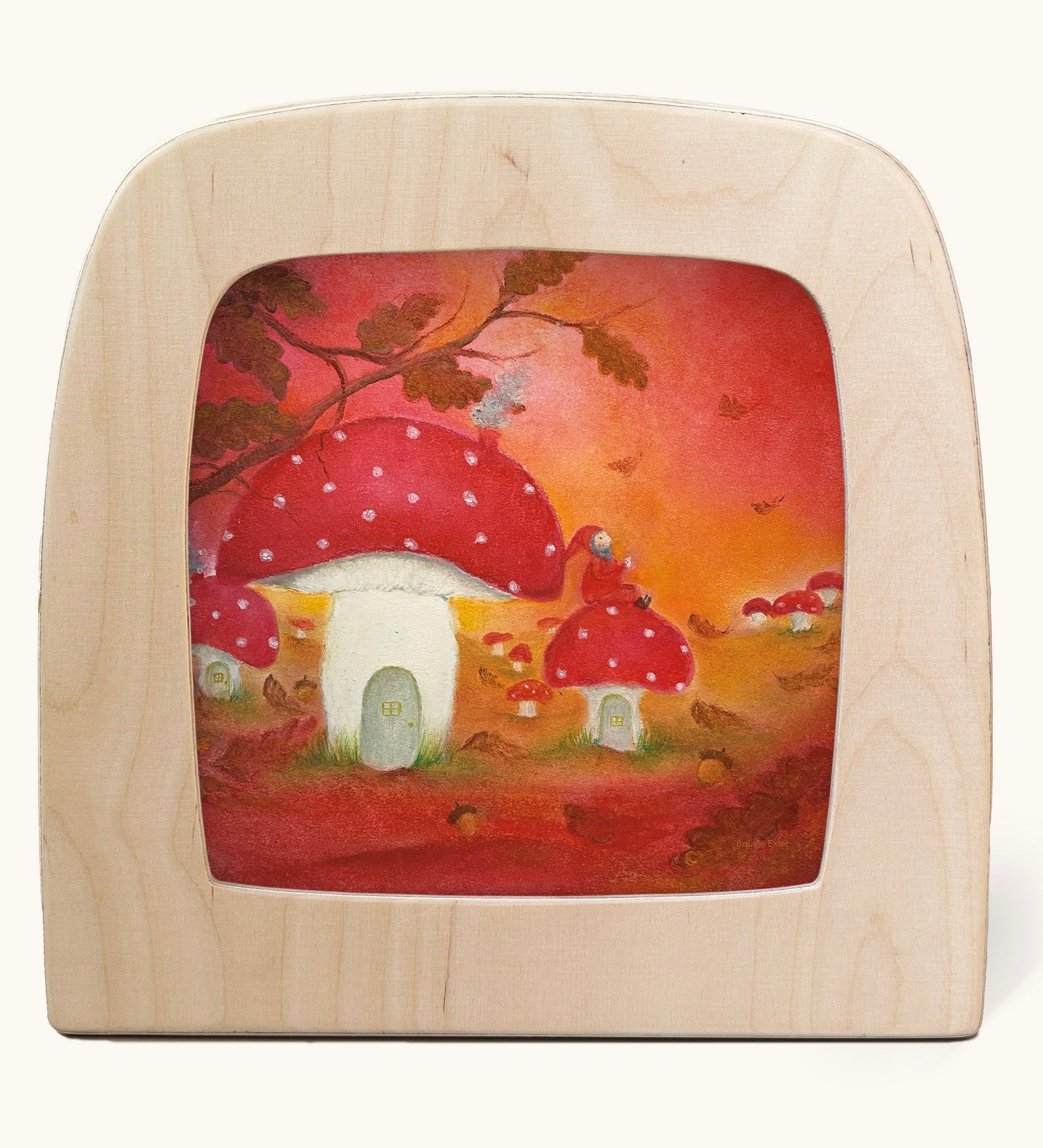A Toverlux silhouette in the magic lamp with red autumn  artwork by Baukje Exler. An illustration of little toadstool houses.