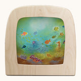 Toverlux underrwater silhouette by Baukje Exler. A pastel illustration of under the sea. Silhouette in wooden magic lamp