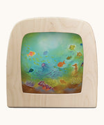 Toverlux underrwater silhouette by Baukje Exler. A pastel illustration of under the sea. Silhouette in wooden magic lamp