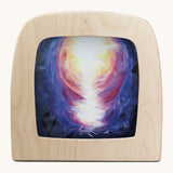 Toverlux hope silhouette by Berit Strasser a oil pastel style of abright light in dark sky. Shows silhouette in a wooden frame