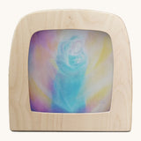 Toverlux light silhouette by Berit Strasser a oil pastel style of mother holding a child. Shows silhouette in a wooden frame