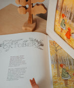 A cosy setup with the Toverlux October silhouette in a wooden lantern by Elsa Beskow available at Babipur.