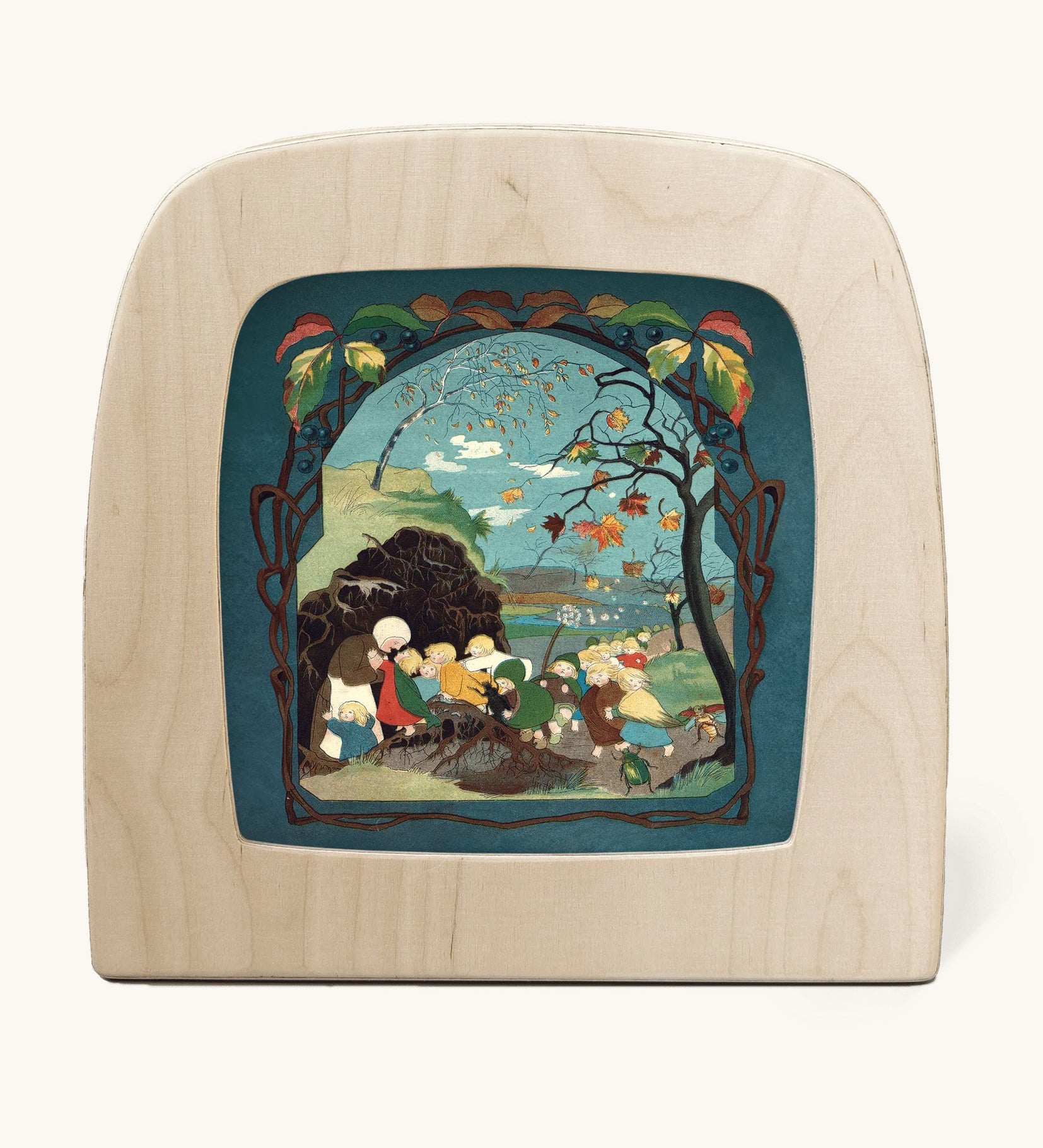 Toverlux magic lamp with a Sibylle Von Olfer Autumn silhouette inside, both available at Babipur. Illustration showing a group of children seeking shelter win a Autumnal scene 