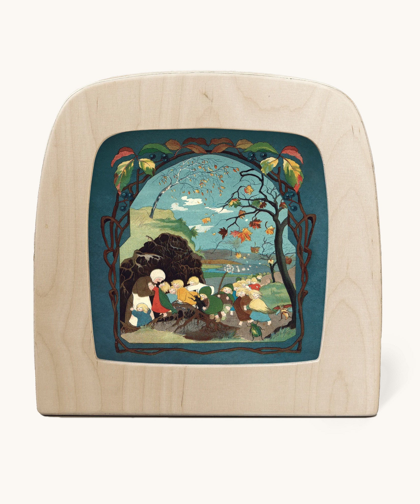 Toverlux magic lamp with a Sibylle Von Olfer Autumn silhouette inside, both available at Babipur. Illustration showing a group of children seeking shelter win a Autumnal scene 