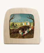 Toverlux magic lamp with a Sibylle Von Olfer spring silhouette inside, both available at Babipur. Illustration showing a group of children carrying flowers underground and above ground.