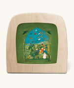 Toverlux magic lamp with a Sibylle Von Olfer Summer silhouette inside, both available at Babipur. Illustration showing a group of children playing in a grassy field with little creatures