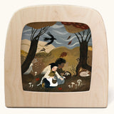 Toverlux Magic Lamp Silhouette Illustration Autumn Treasures by Tijana Draws. The artwork features two people kneeling down in a forest scene foraging mushrooms. We have a range of Toverlux silhouettes, lamps and accessories available at Babipur.